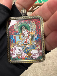 Buddhist pendant with deity painting in ornate frame, featuring white elephant and lotus flower
