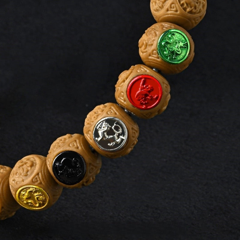 Four Symbols Taoist Bracelet – 10mm carved monkey head beads with Four Celestial Beasts. Monk-blessed for spiritual protection & cosmic harmony