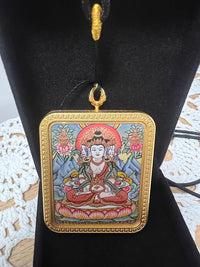 Gold framed Buddhist pendant with Avalokiteshvara artwork on black display stand