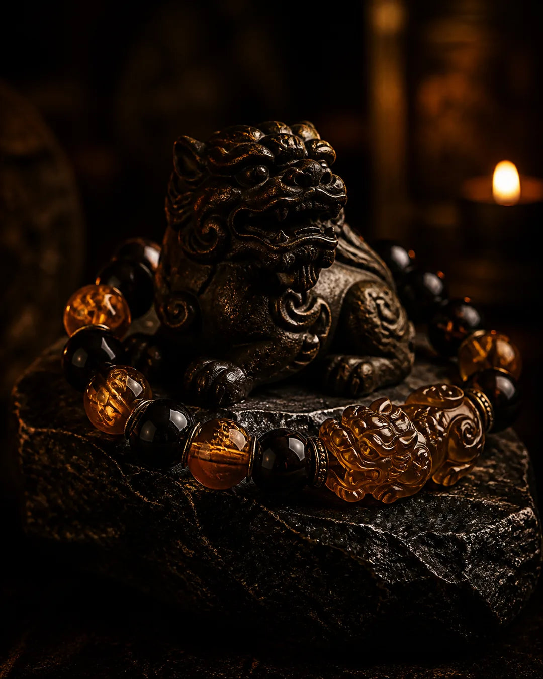 Amber and jade guardian pieces on dark Tibetan wood