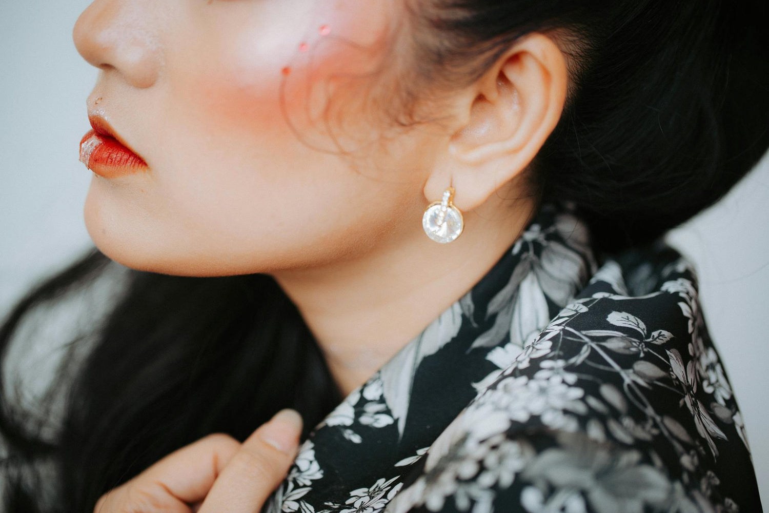 yin yang earrings - Close-up portrait of a woman showcasing elegant earrings and makeup | Buddhabelief