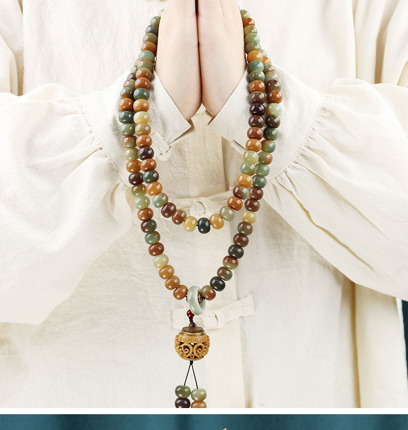 Tibetan jade prayer beads necklace with 108 mala beads, person holding rosary in prayer for meditation and mindfulness