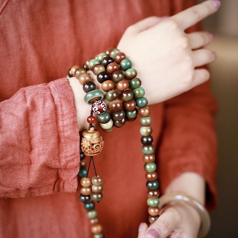 Person wearing Tibetan jade mala bracelet with 108 prayer beads, meditation jewelry for mindfulness and spiritual practice