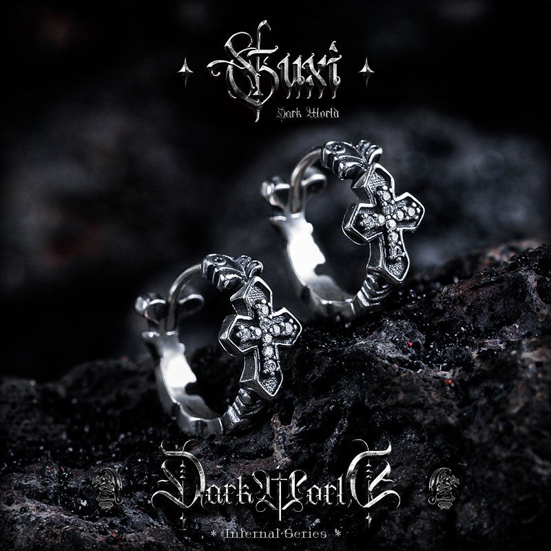 Close-up textured silver hoops with diamond cross dangles gothic style