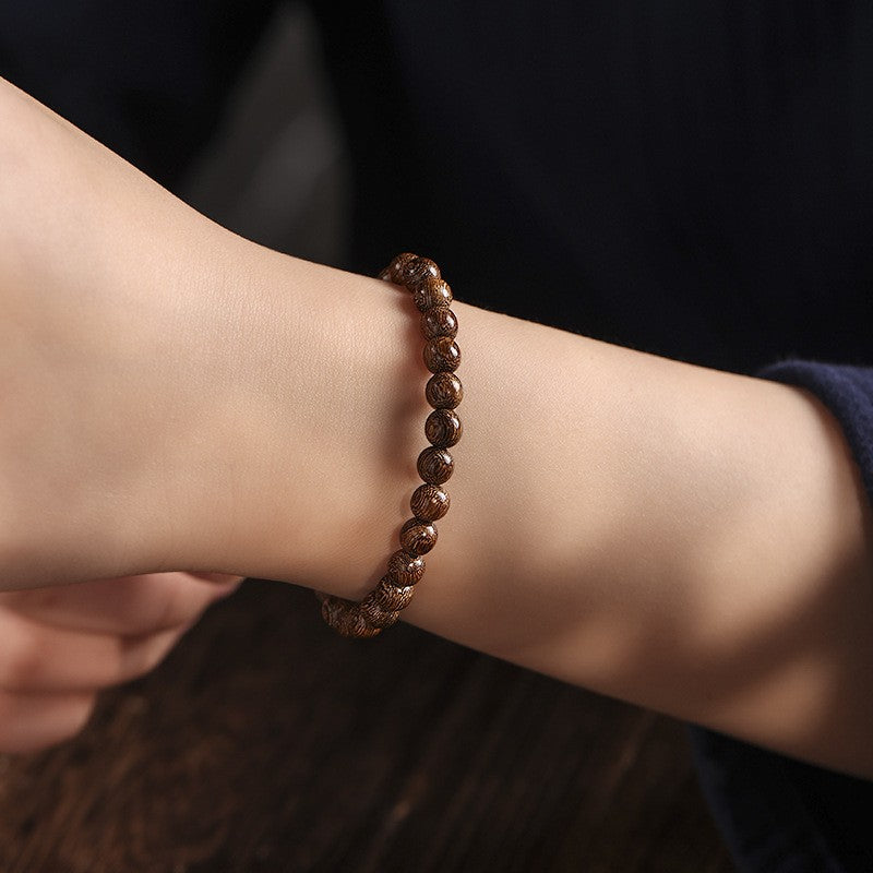 Golden-grain wood bracelet shown on a wrist