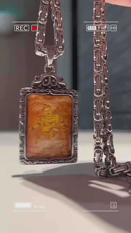 Tibetan Buddhist amulet pendant with golden deity carving in silver frame and chain, spiritual protection jewelry video