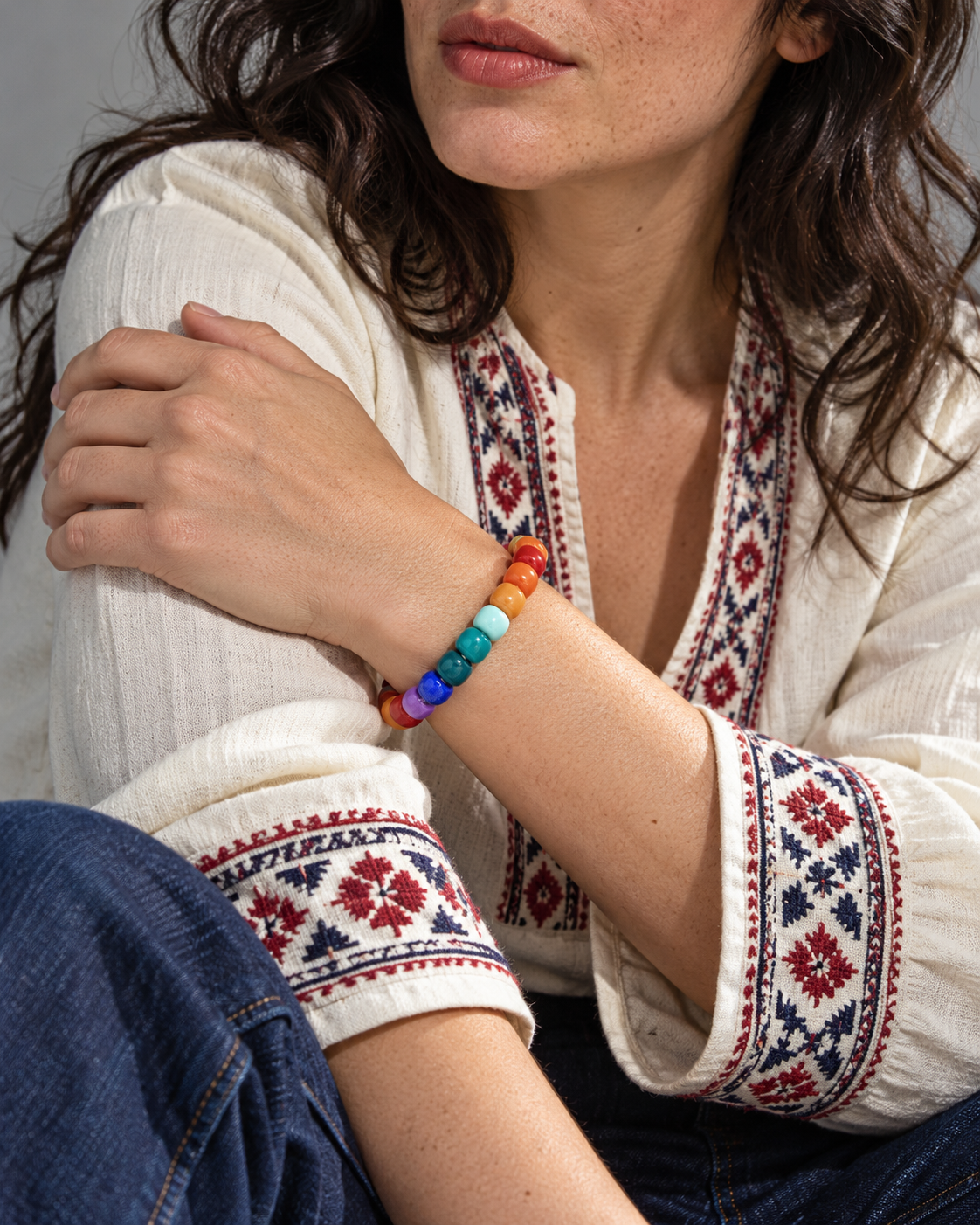 Editorial wrist styling with a multicolored bead bracelet